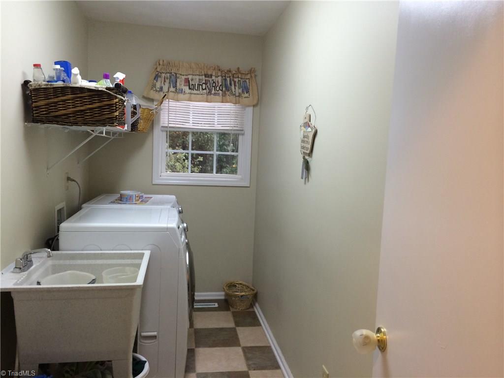 5241 Rena Road Hamptonville, NC 27020 - Photo 11 of 22 Main Level Hall Laundry with Washer & Dryer Hookups, Wet Sink, and Tile Floor
