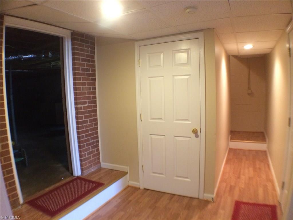 5241 Rena Road Hamptonville, NC 27020 - Photo 12 of 22 Lower Level Finished Hallway, Laminate Flooring and Drop Ceiling.
