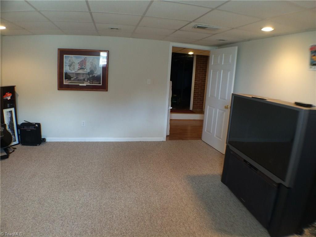 5241 Rena Road Hamptonville, NC 27020 - Photo 13 of 22 Lower Level Den with Carpet, Drop Ceiling, and Recessed Lighting