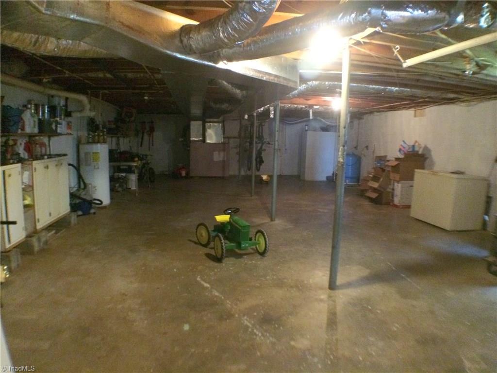 5241 Rena Road Hamptonville, NC 27020 - Photo 15 of 22 Original Home Unfinished Basement. Updated Water Heater, HVAC Duck work, Updated Pressure Tank, Updated to Plastic Plumbing, and a Block Shower. Chest Freezer and Wood Stove do NOT stay.