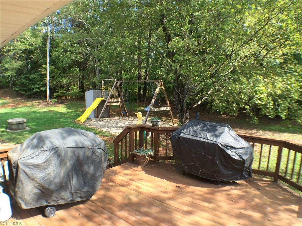 5241 Rena Road Hamptonville, NC 27020 - Photo 17 of 22 Rear Grilling Deck and Play Area. Swing Set and Storage Container are not included.