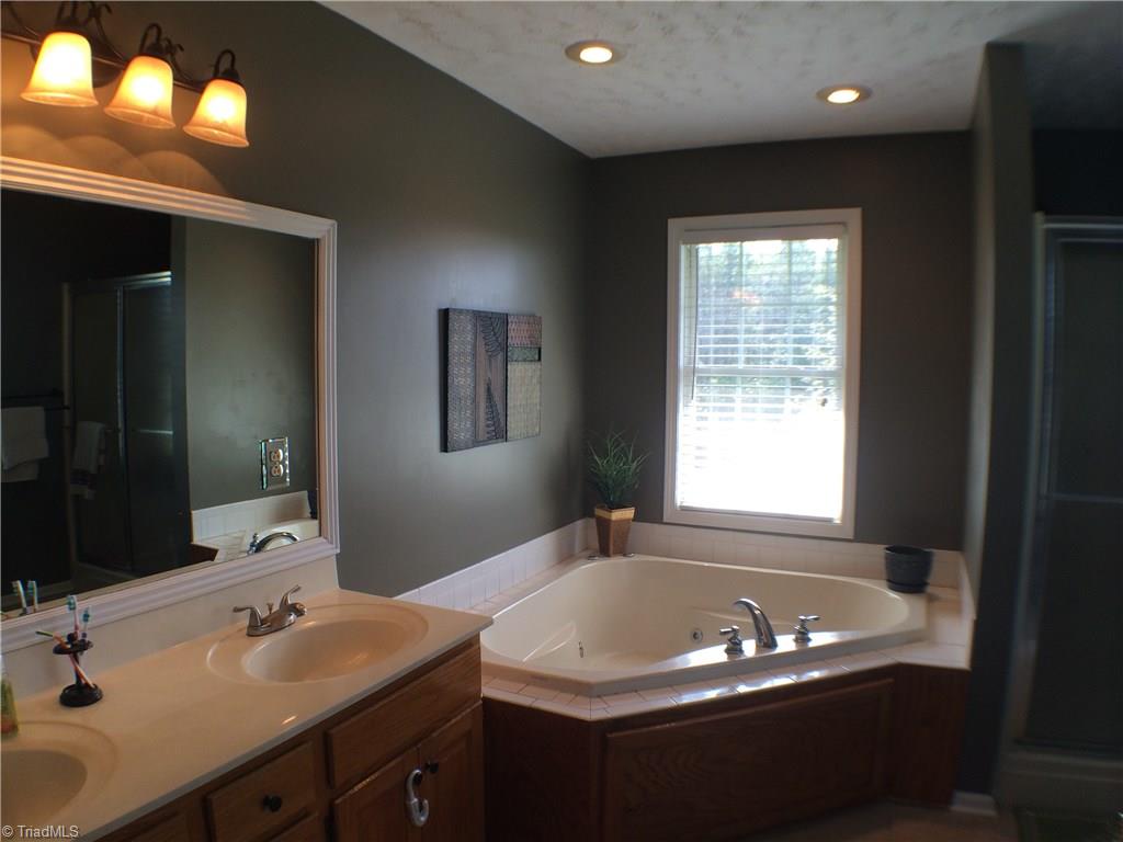 5241 Rena Road Hamptonville, NC 27020 - Photo 6 of 22 Double Vanity with solid top, Jetted Aqua Tub, Separate Shower with Seat, Tile Floor, and Recessed Lighting