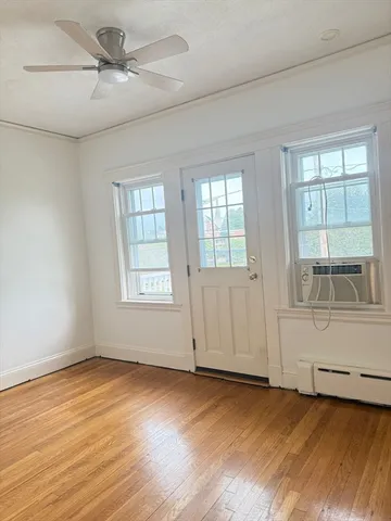 an empty room with windows and ceiling fan view