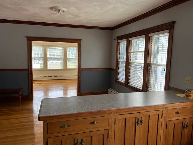 a view of a livingroom with wooden floor and a fireplace