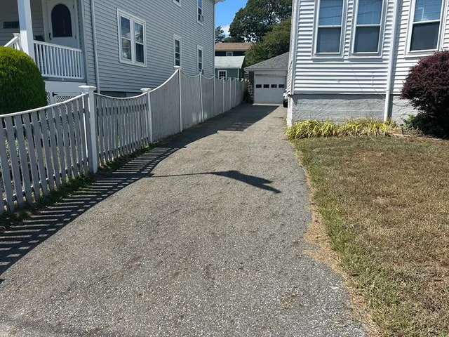 a view of a house with wooden fence