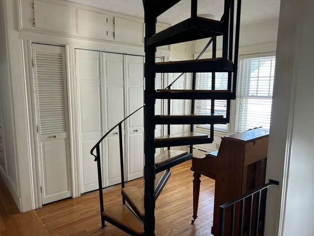 a view of an entryway with wooden floor and door