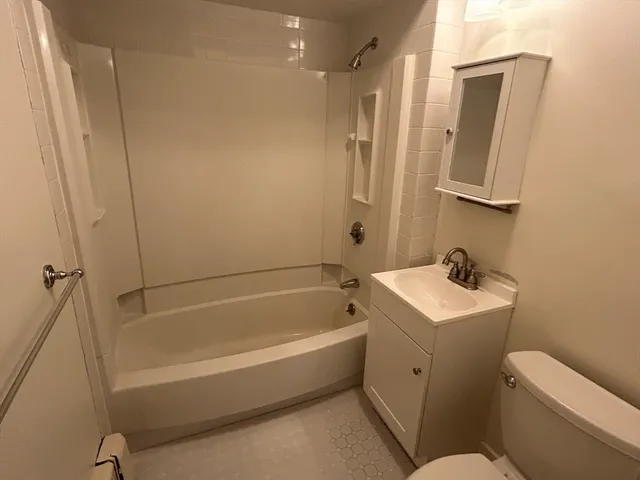 a bathroom with double vanity sinks and a mirror