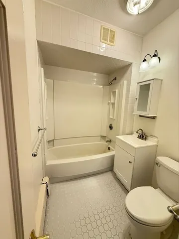 a bathroom with a toilet a sink and bathtub