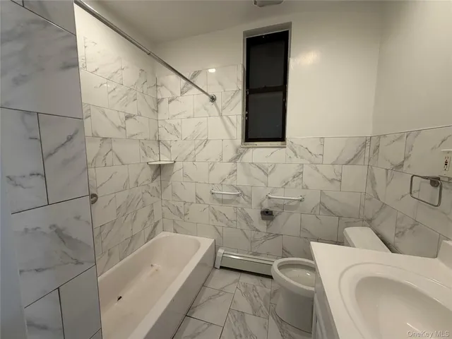 a bathroom with a toilet and bathtub
