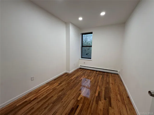 a view of an empty room and wooden floor
