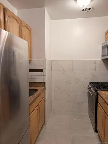 a kitchen with cabinets and appliances