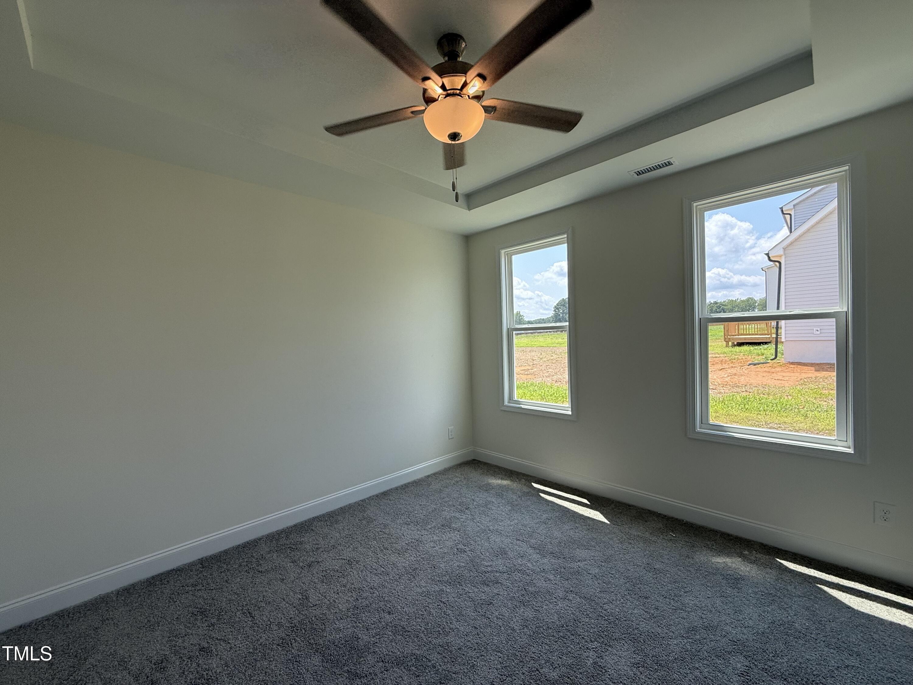 432 Springtooth Drive Zebulon, NC 27597 - Photo 7 of 15 an empty room with windows and fan