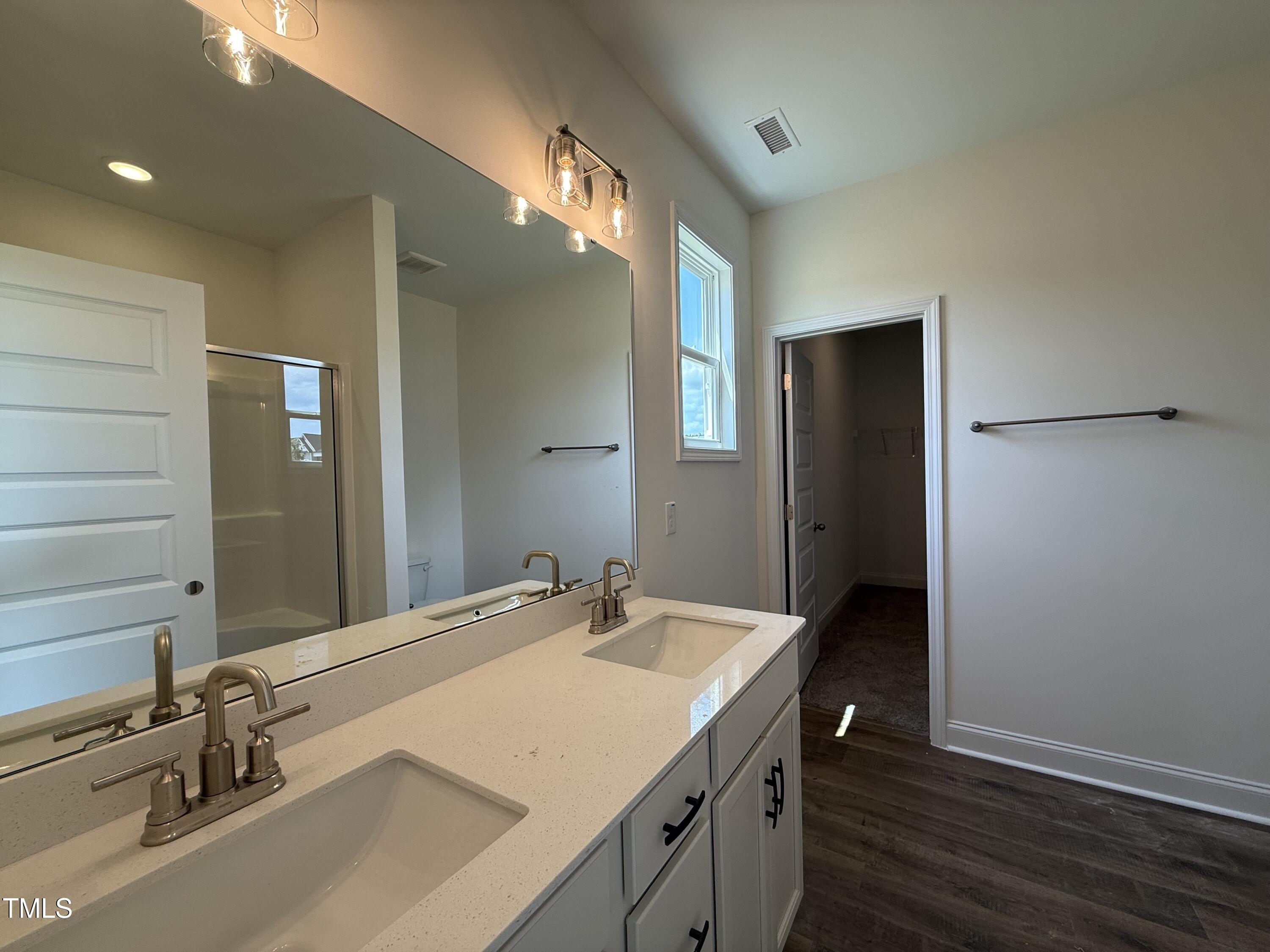 432 Springtooth Drive Zebulon, NC 27597 - Photo 8 of 15 a bathroom with a sink and a mirror