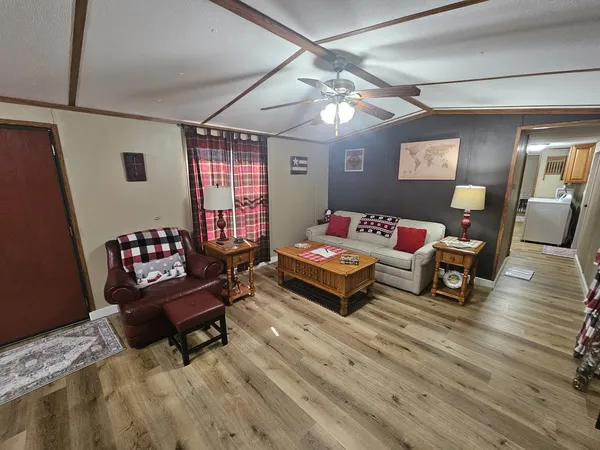 a kitchen with a table chairs and wooden floor