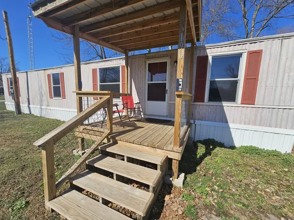 a view of a house with a yard and sitting area