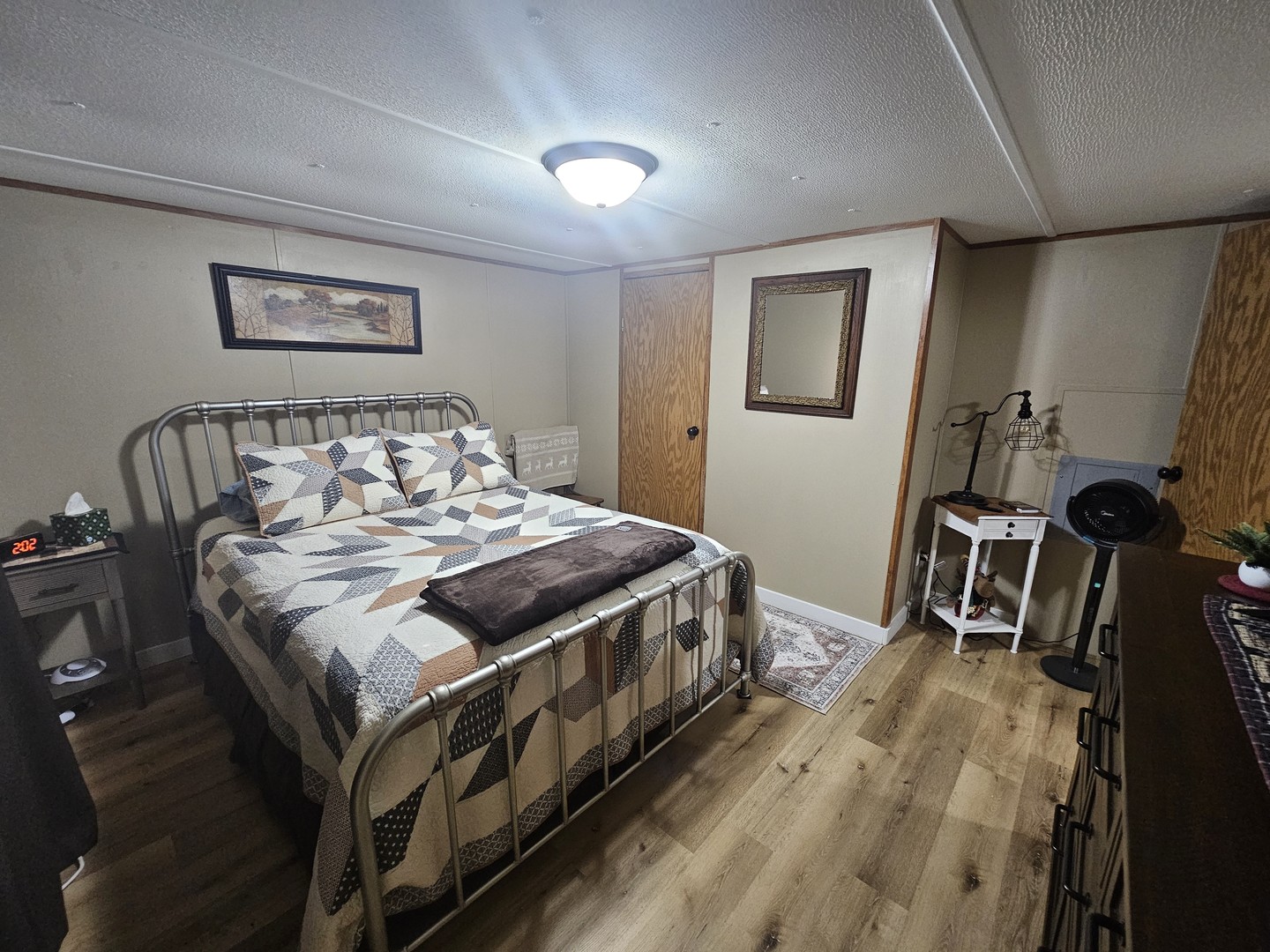 190 West 5th Street Bonnie, IL 62816 - Photo 22 of 25 a bedroom with a bed and a table with wooden floor