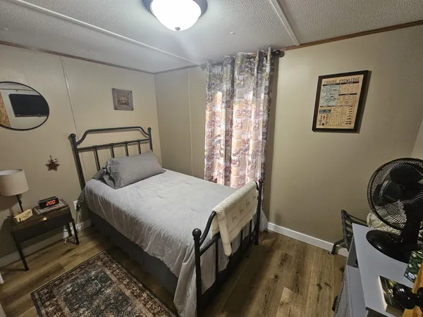 a bedroom with a bed and a window