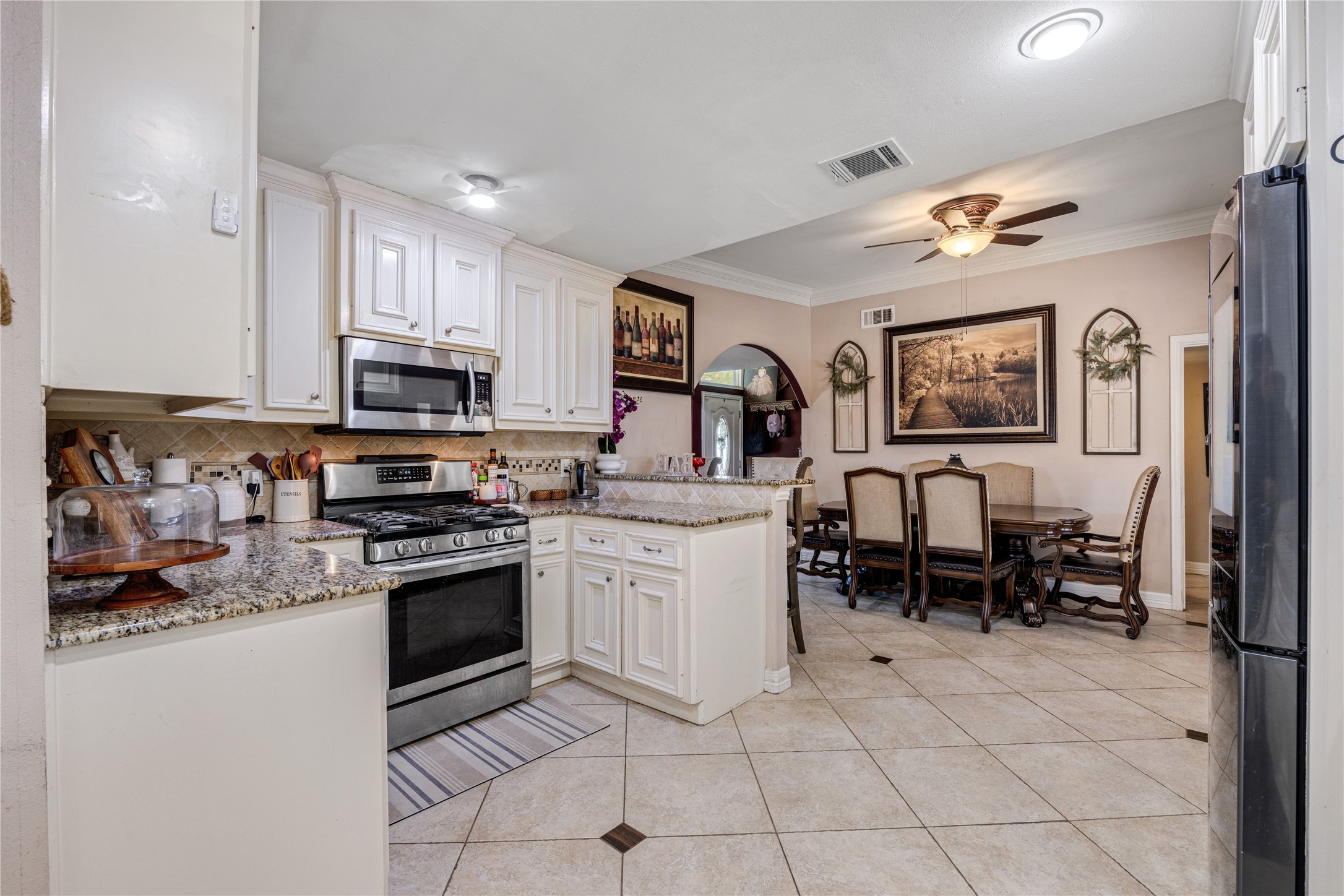 922 Gilpin Street Houston, TX 77034 - Photo 13 of 26 a kitchen with stainless steel appliances granite countertop a stove top oven a sink dishwasher and a refrigerator