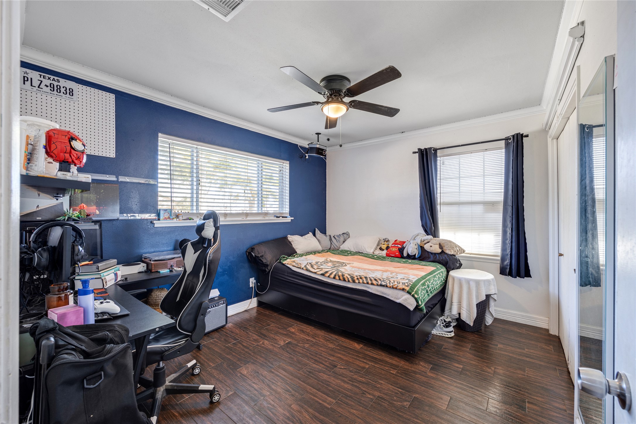 922 Gilpin Street Houston, TX 77034 - Photo 15 of 26 a bedroom with a bed and a chandelier