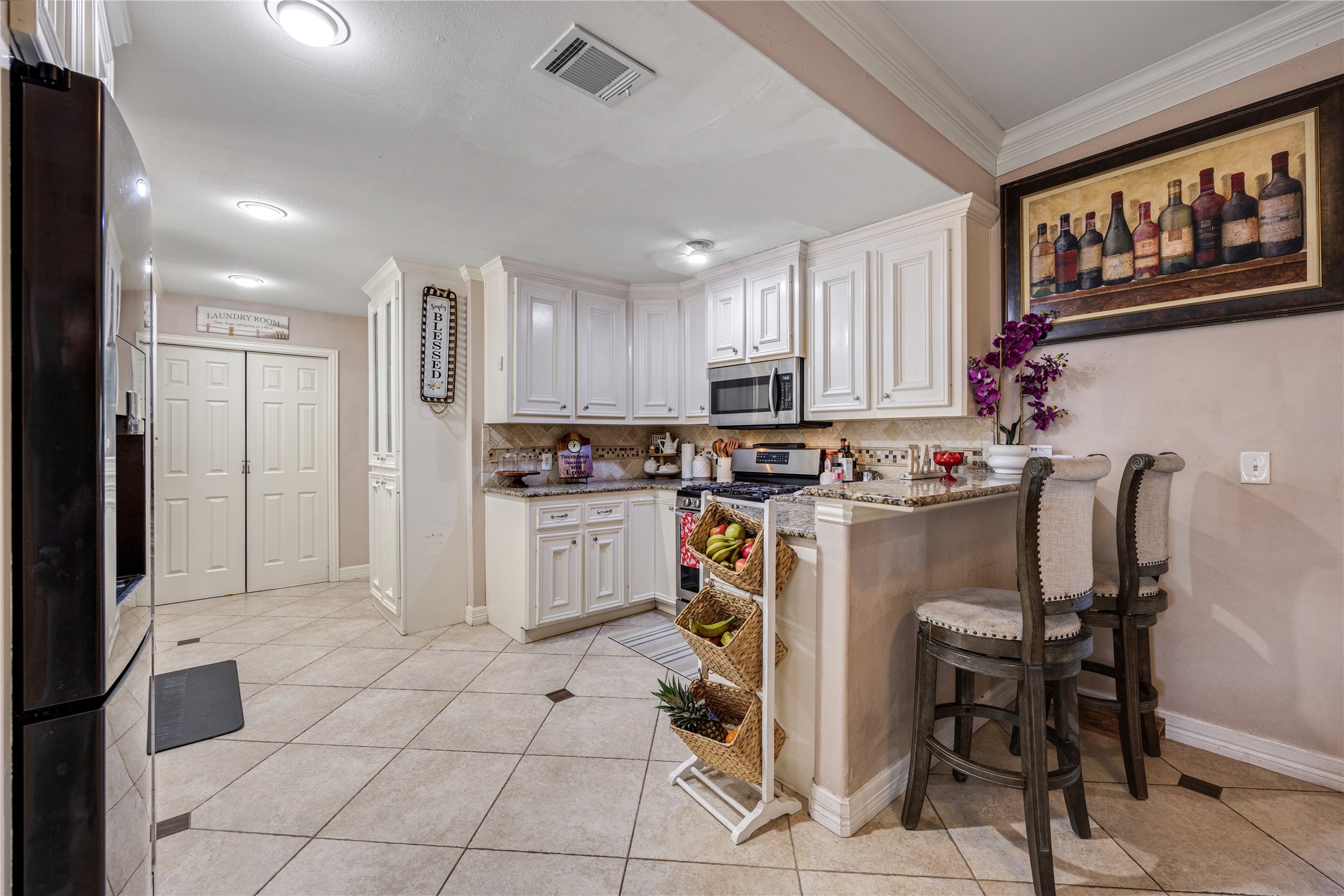 922 Gilpin Street Houston, TX 77034 - Photo 9 of 26 a kitchen with a refrigerator and cabinets
