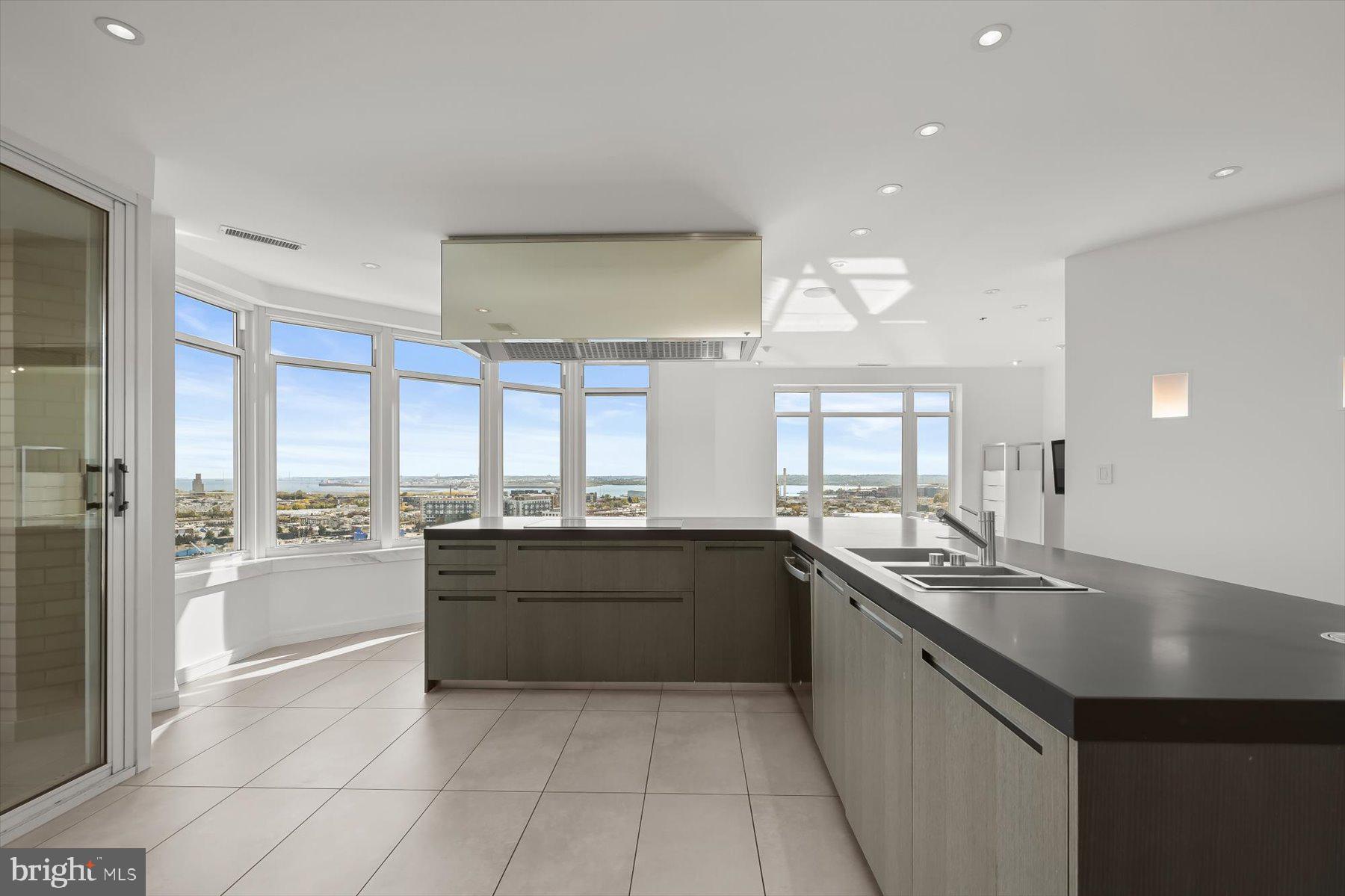 100 Harborview Drive, Unit 1901 Baltimore, MD 21230 - Photo 21 of 107 a large kitchen with kitchen island a sink a stove and a refrigerator