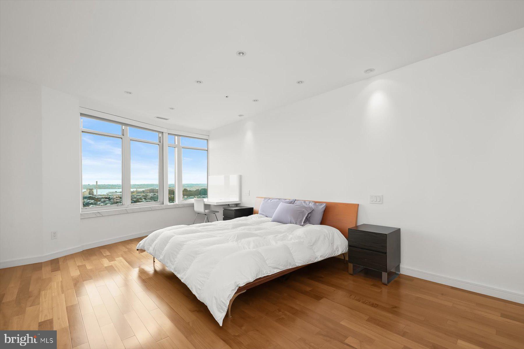 100 Harborview Drive, Unit 1901 Baltimore, MD 21230 - Photo 31 of 107 a bedroom with a bed and a large window