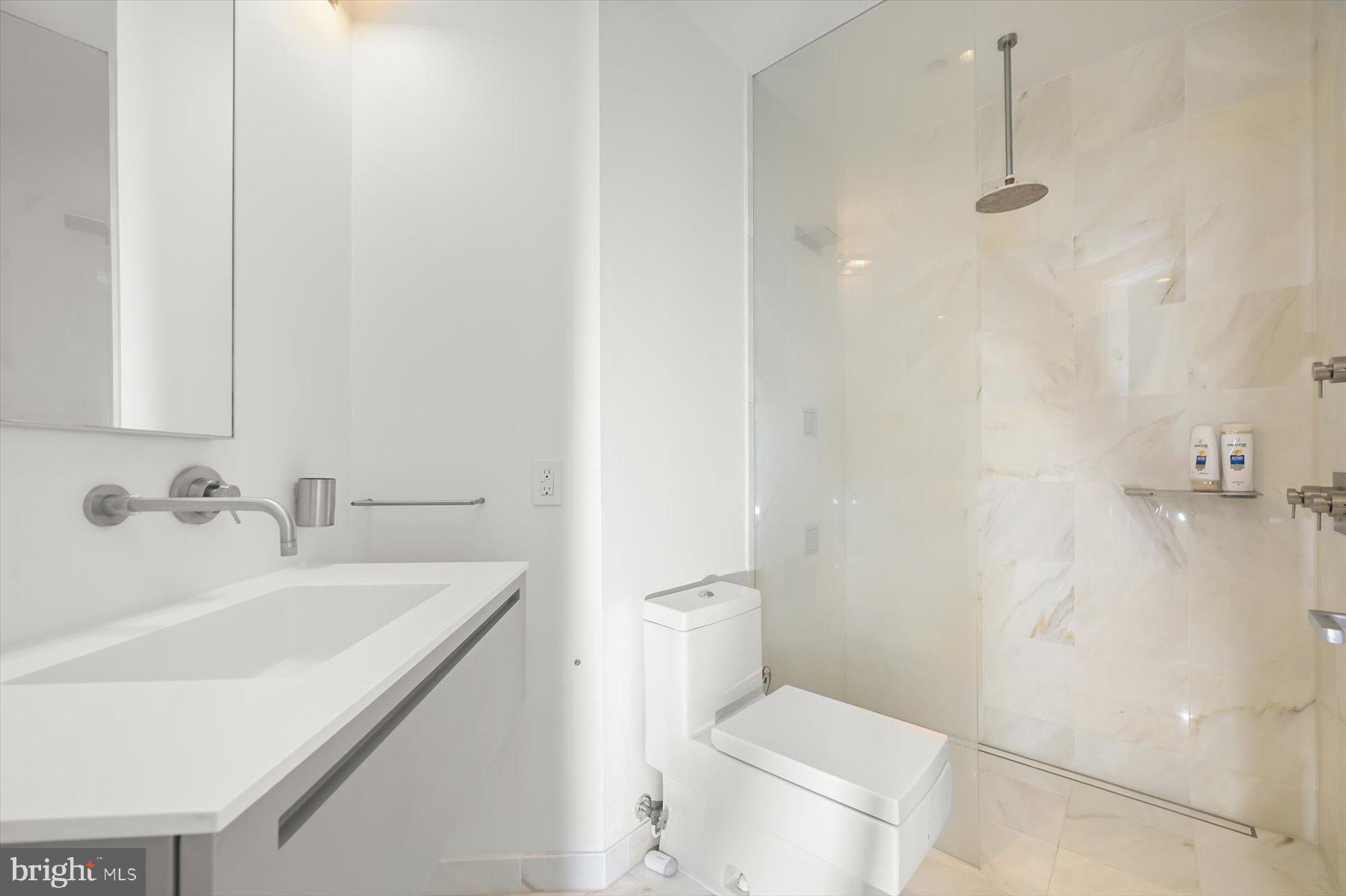 100 Harborview Drive, Unit 1901 Baltimore, MD 21230 - Photo 53 of 107 a bathroom with a sink a toilet and shower