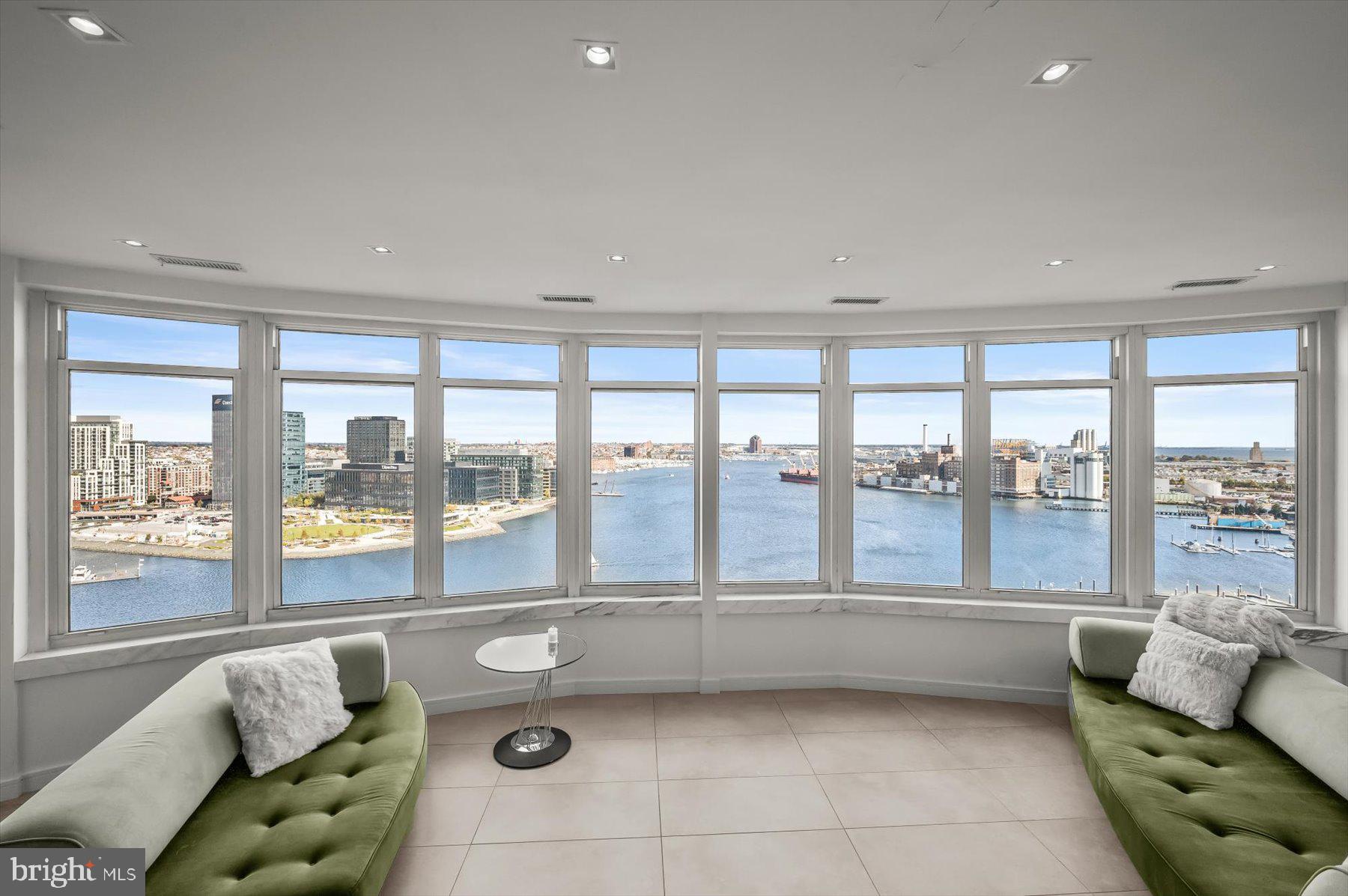 100 Harborview Drive, Unit 1901 Baltimore, MD 21230 - Photo 68 of 107 a living room with furniture and floor to ceiling windows
