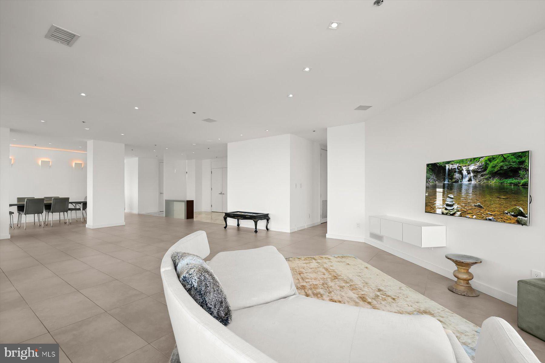 100 Harborview Drive, Unit 1901 Baltimore, MD 21230 - Photo 10 of 107 a living room with furniture and a flat screen tv