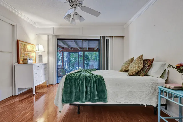a view of a bedroom with furniture and wooden floor