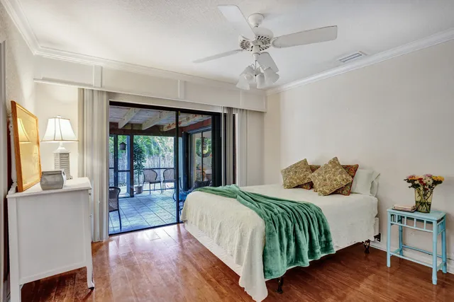a bedroom with a bed and large window