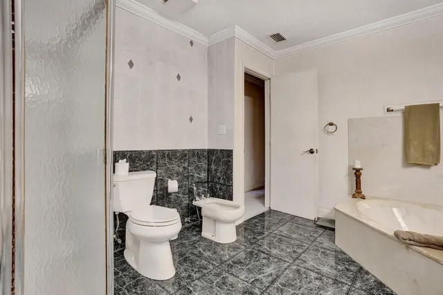 a dining room with furniture and a floor to ceiling window