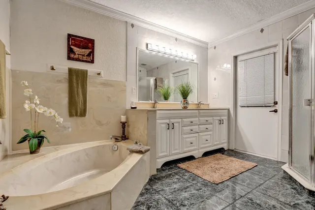 a view of a patio with a table and chairs and potted plants