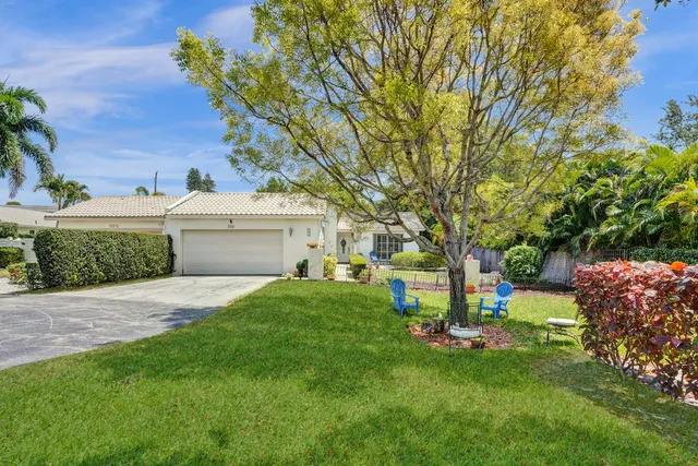 a view of a house with backyard and sitting area