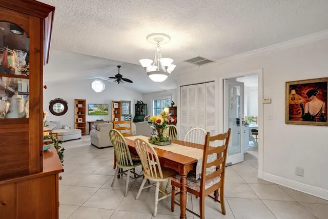 a kitchen with stainless steel appliances granite countertop a refrigerator a stove a sink dishwasher and white cabinets with wooden floor