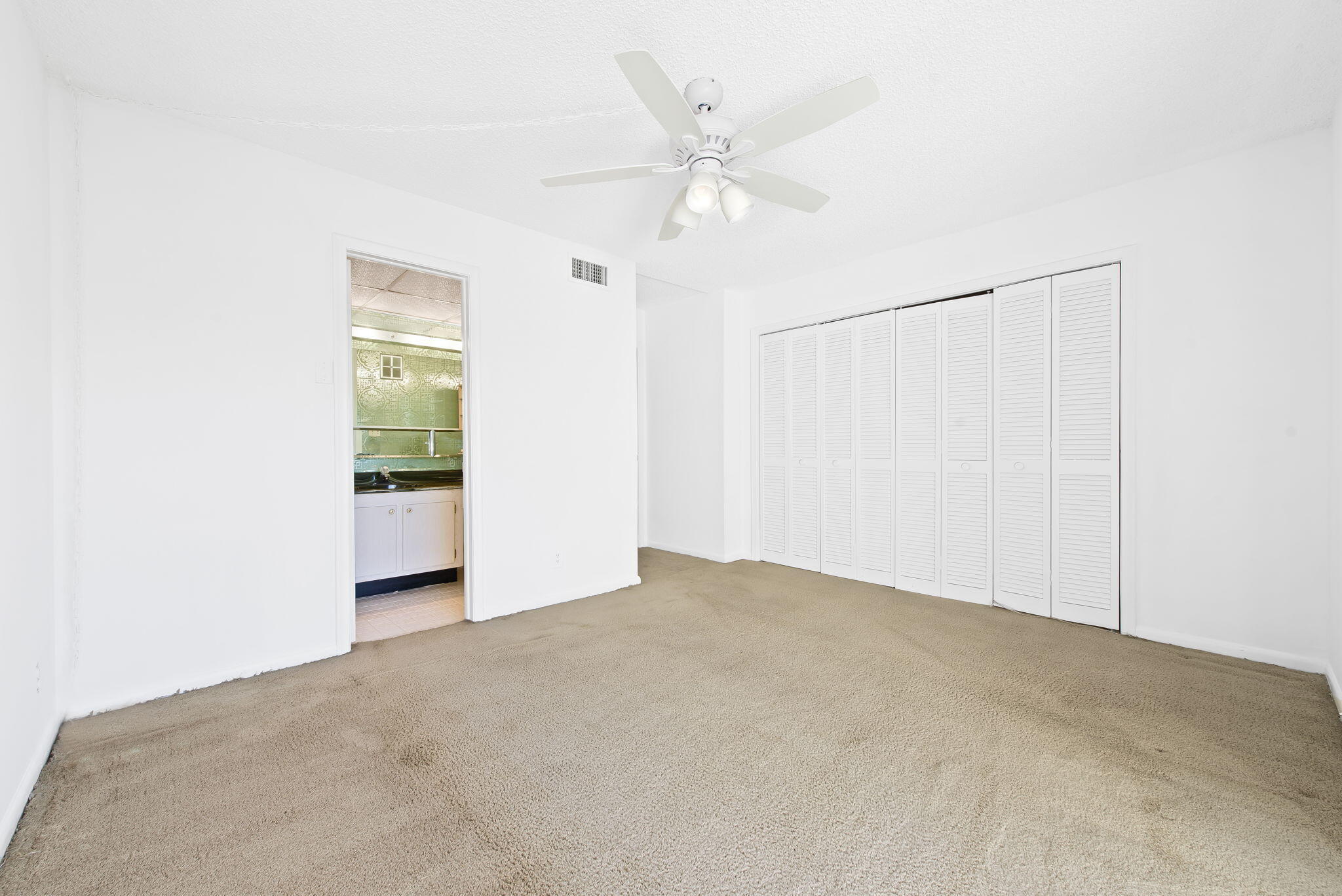 6491 Racquet Club Drive, Unit 36 Lauderhill, FL 33319 - Photo 14 of 24 an empty room with a ceiling fan and a window