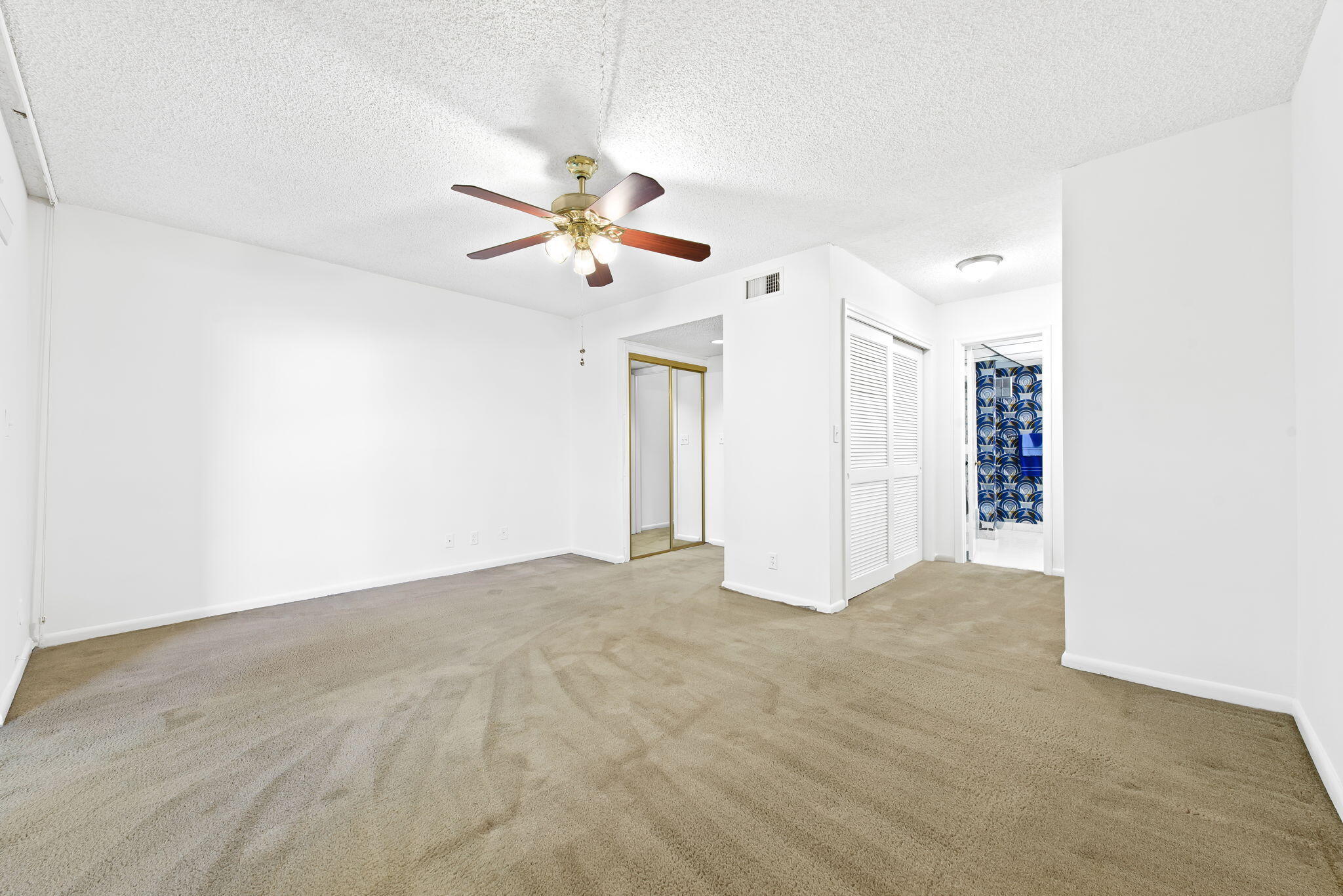 6491 Racquet Club Drive, Unit 36 Lauderhill, FL 33319 - Photo 19 of 24 a view of an empty room with chandelier fan