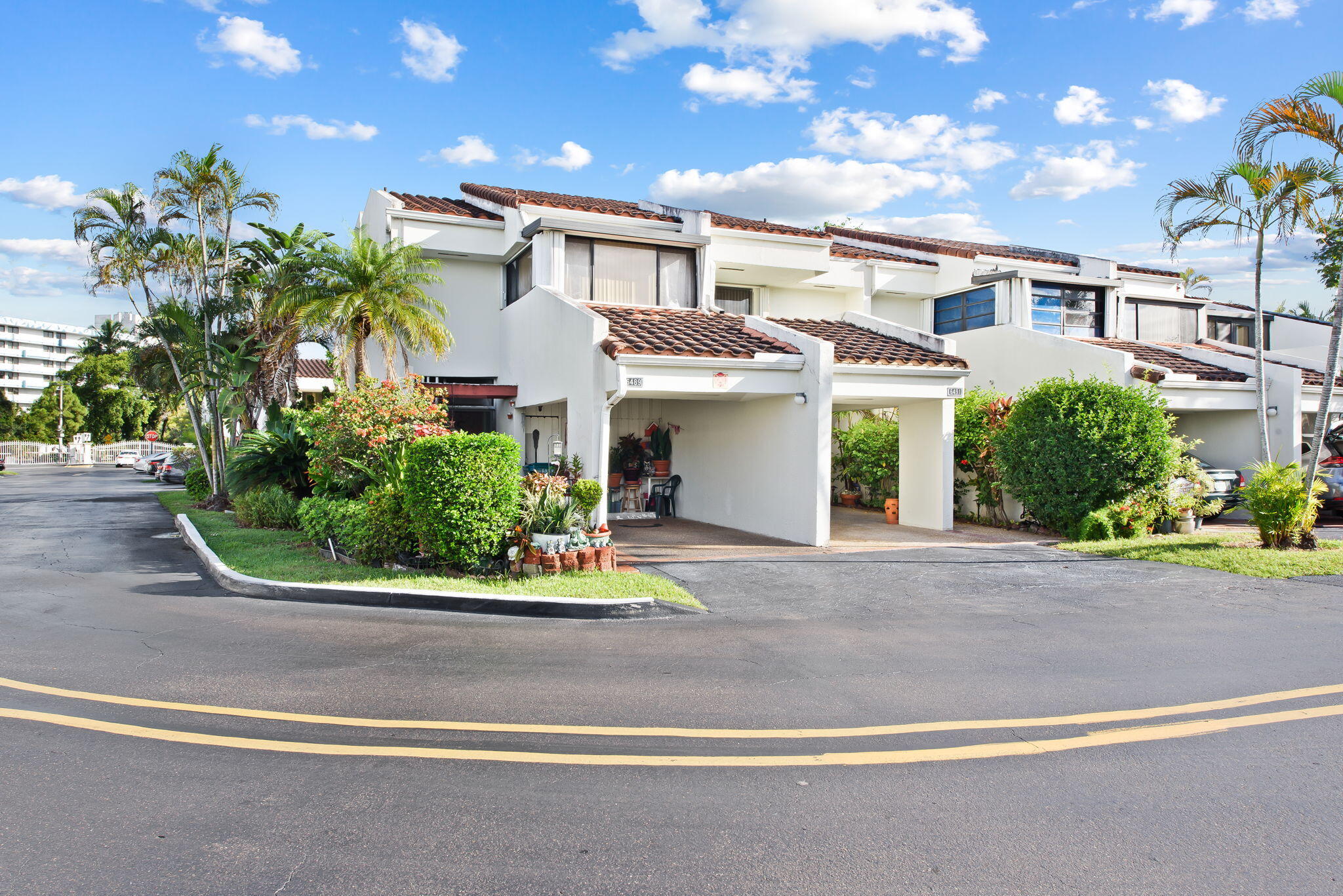 6491 Racquet Club Drive, Unit 36 Lauderhill, FL 33319 - Photo 24 of 24 a front view of a house with a yard and potted plants
