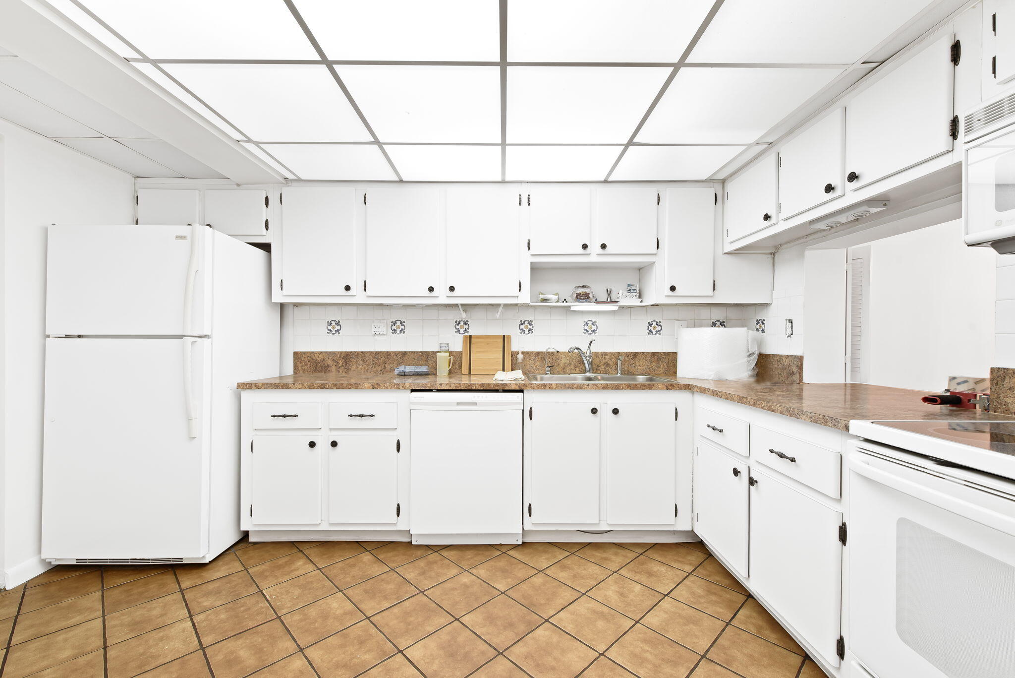 6491 Racquet Club Drive, Unit 36 Lauderhill, FL 33319 - Photo 3 of 24 a kitchen with cabinets window and stainless steel appliances