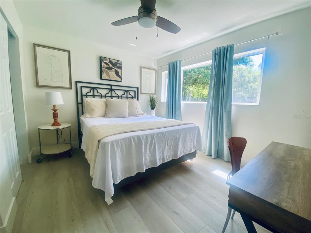 415 Mapleway, Unit A & B Safety Harbor, FL 34695 - Photo 35 of 56 a bedroom with a bed table chair and a window