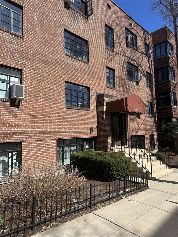 69 A Strathmore Road, Unit 69A Boston, MA 02135 - Photo 1 of 12 a front view of a house with a garden