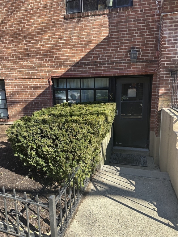 69 A Strathmore Road, Unit 69A Boston, MA 02135 - Photo 4 of 12 a front view of a house with a garden