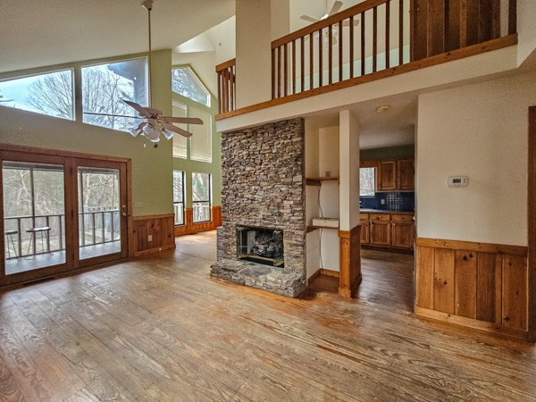 104 Pine Ridge Road Ellijay, GA 30536 - Photo 39 of 49 a view of a livingroom with furniture a fireplace wooden floor and chandelier