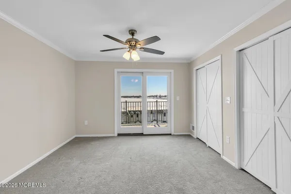 a view of a livingroom with a ceiling fan and window