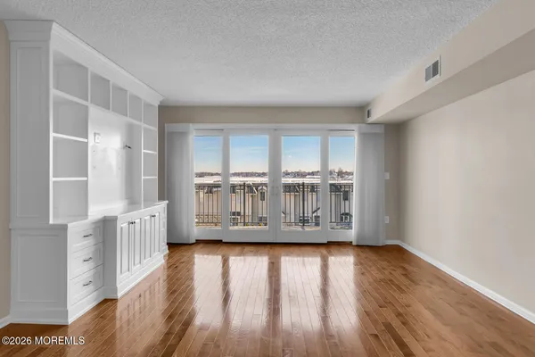 a view of wooden floor and windows in a room