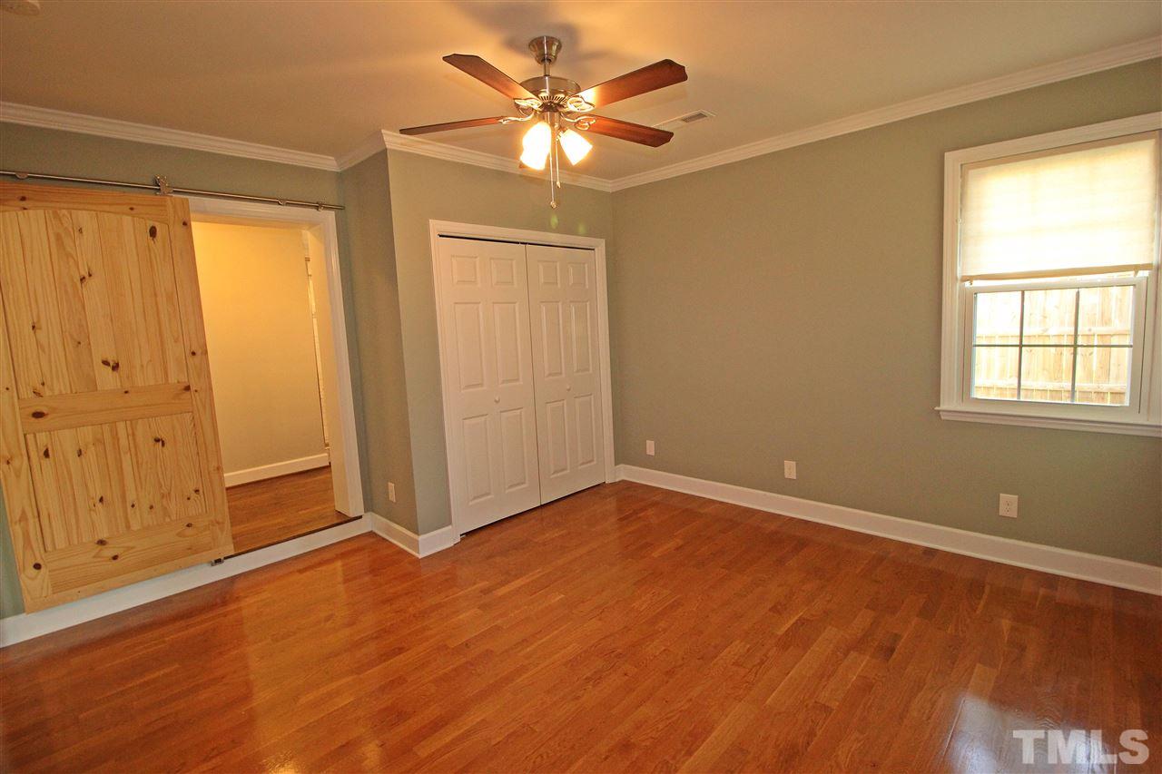 2449 Milburnie Road Raleigh, NC 27610 - Photo 14 of 25 a view of an empty room with window and a chandelier fan