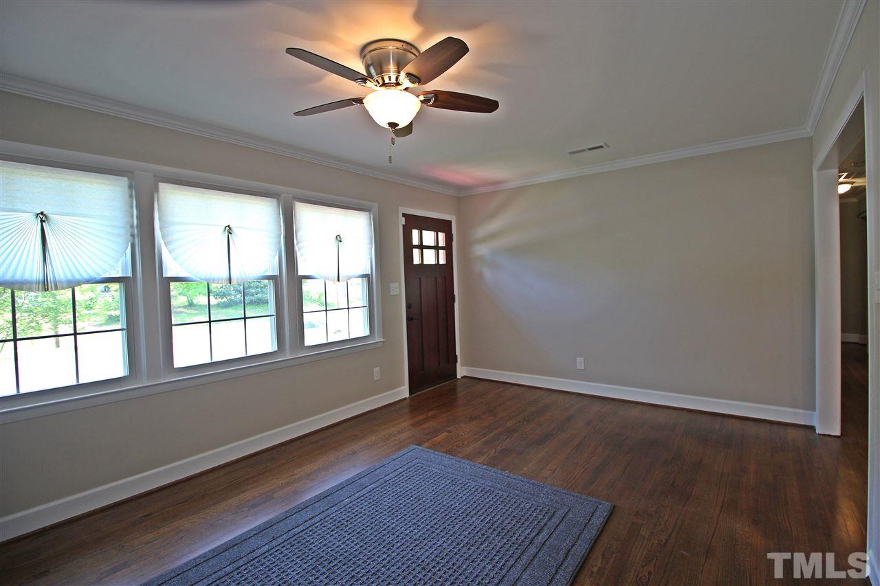 2449 Milburnie Road Raleigh, NC 27610 - Photo 3 of 25 an empty room with wooden floor and windows