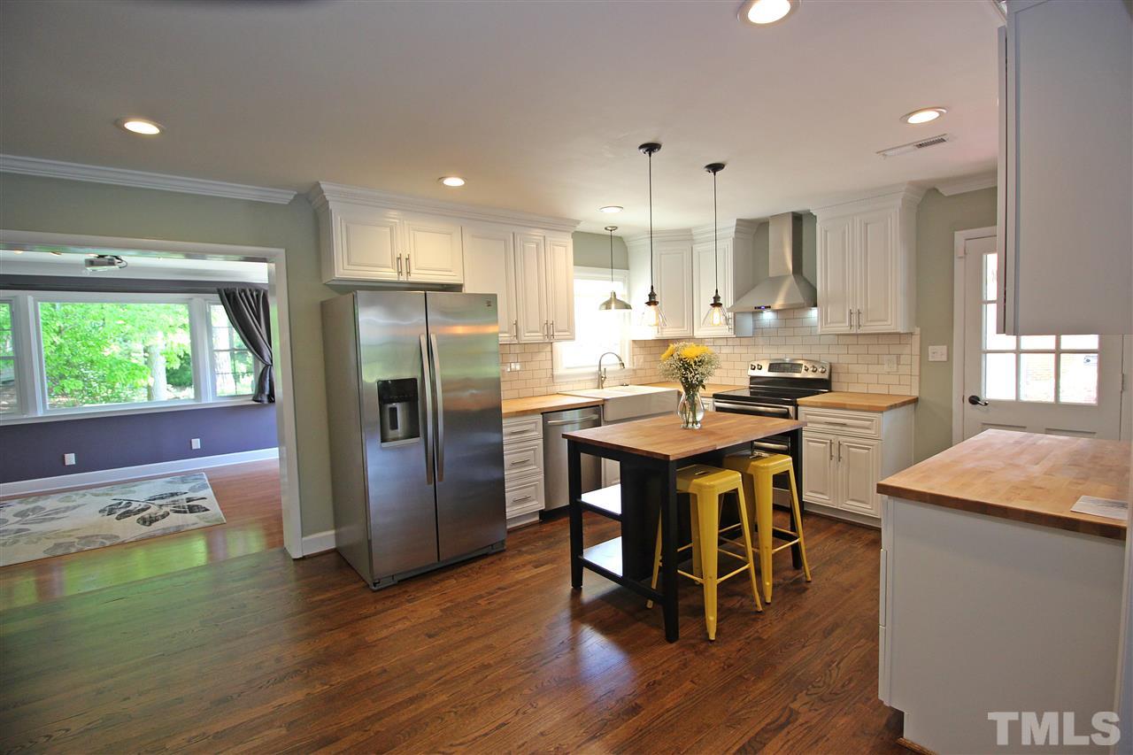 2449 Milburnie Road Raleigh, NC 27610 - Photo 4 of 25 a kitchen with a table and chairs