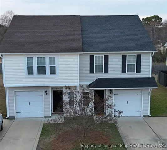 a front view of a house with garage