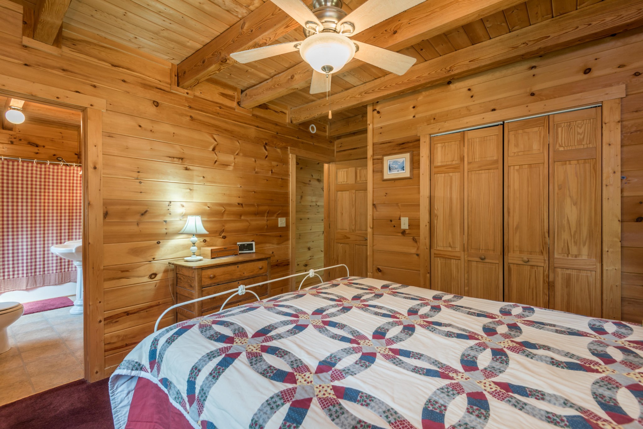 3104 Clearview Road Sevierville, TN 37862 - Photo 24 of 36 a bedroom with a bed and a chandelier